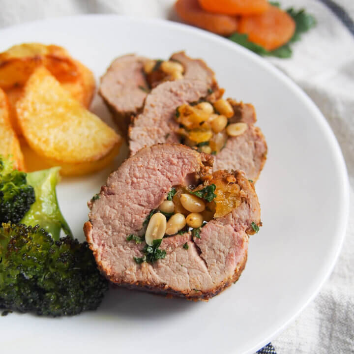 slices of apricot stuffed pork tenderloin on plate