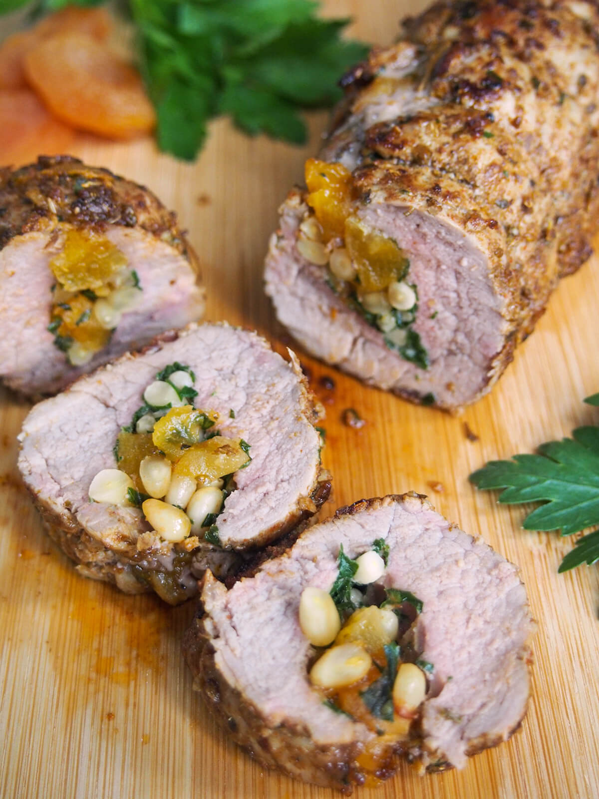 slices of apricot stuffed pork tenderloin in front of rest of roll