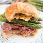 asparagus parmesan burger with bites taken from it