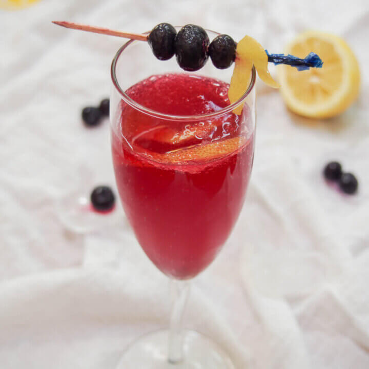 glass of blueberry French 75