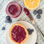 jar of blueberry curd and some on bread onplate from overhead