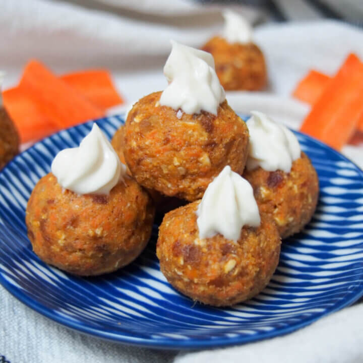 carrot cake energy bites stacked on small plate