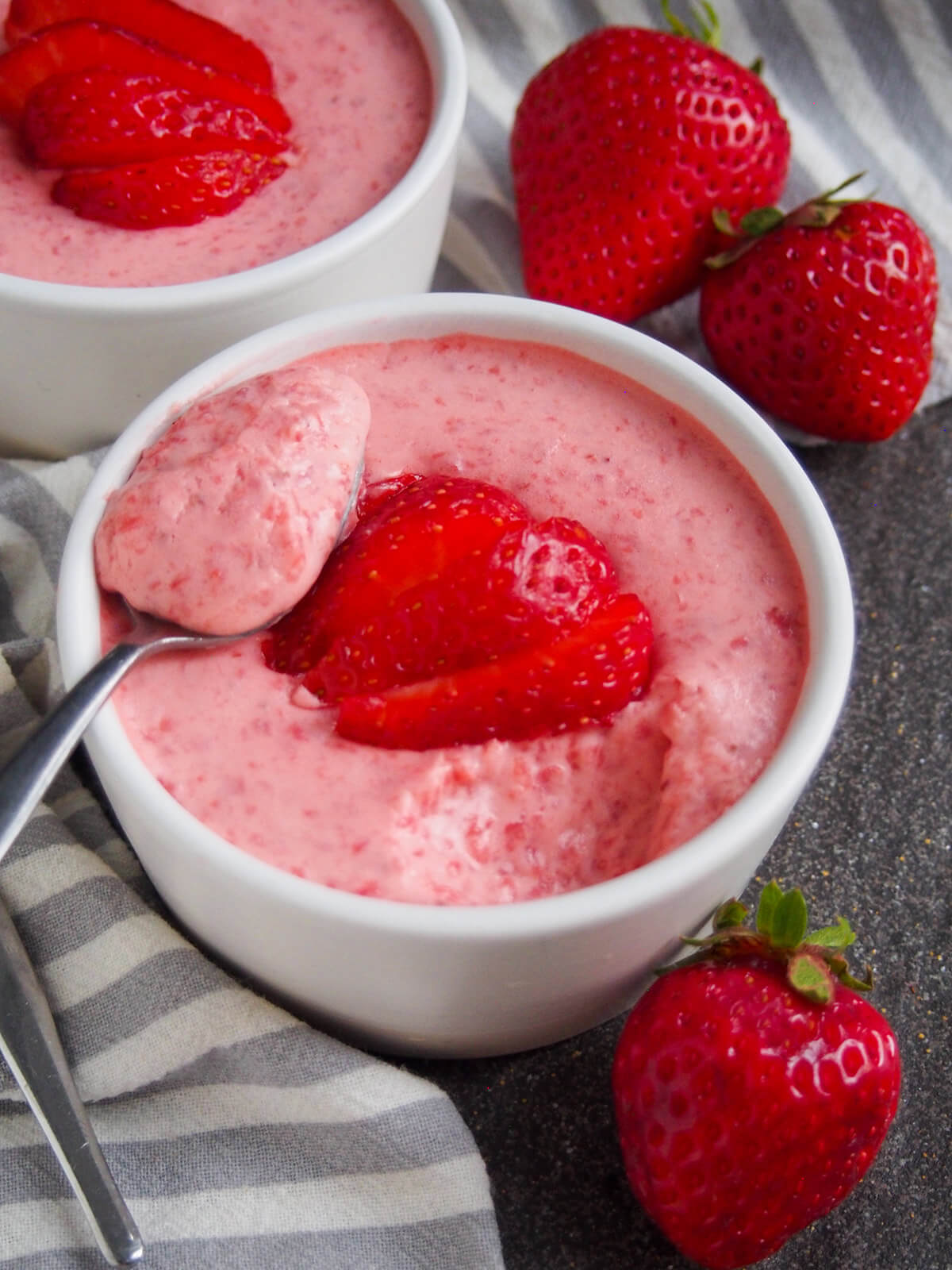 spoonful of easy strawberry mousse resting on top of dish with rest