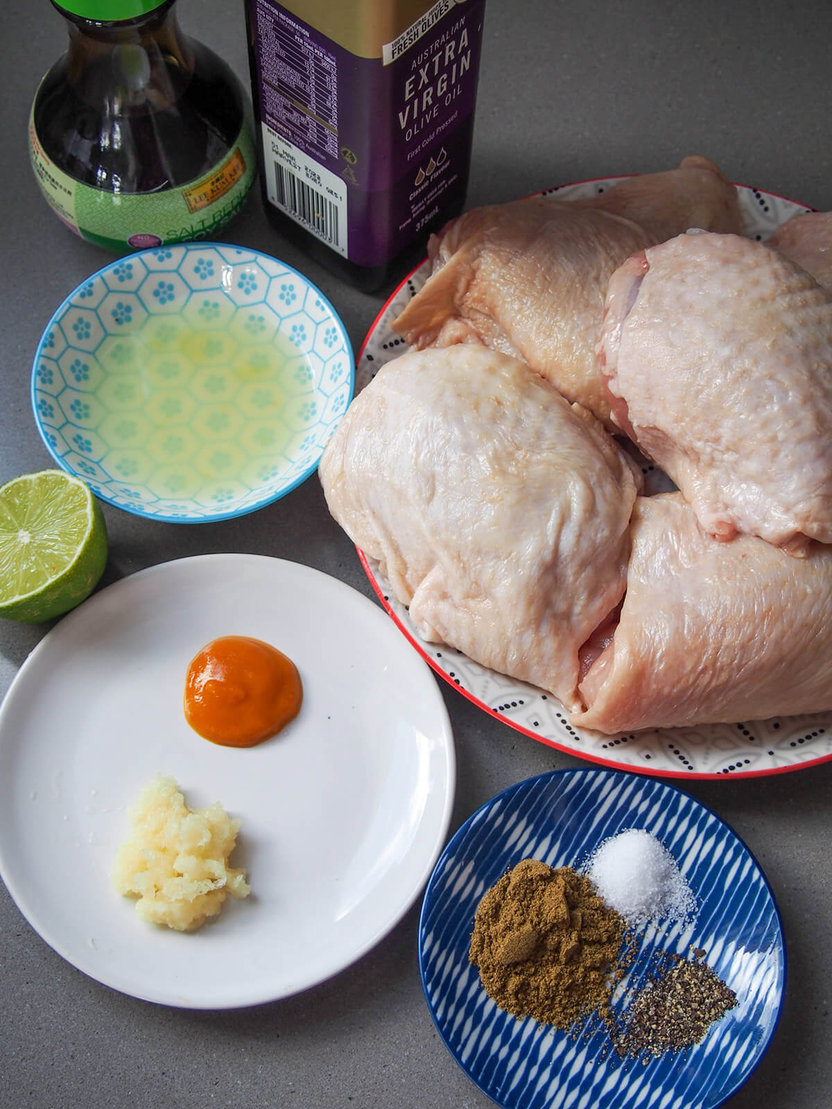 ingredients for pollo a la brasa, Peruvian roast chicken chicken pieces, lime juice, oil, soy, chili, garlic and spices