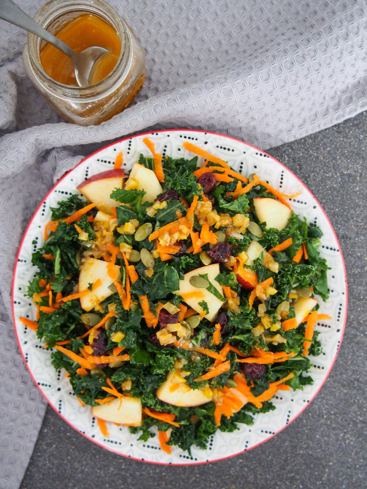 This preserved lemon vinaigrette/dressing is a delicious mix of tangy lemon and warm spice flavors. It works particularly well with crunchy autumnal/winter salads but would also be great mixed through couscous and more. Kale salad with preserved lemon vinaigrette drizzled over top and jar to side