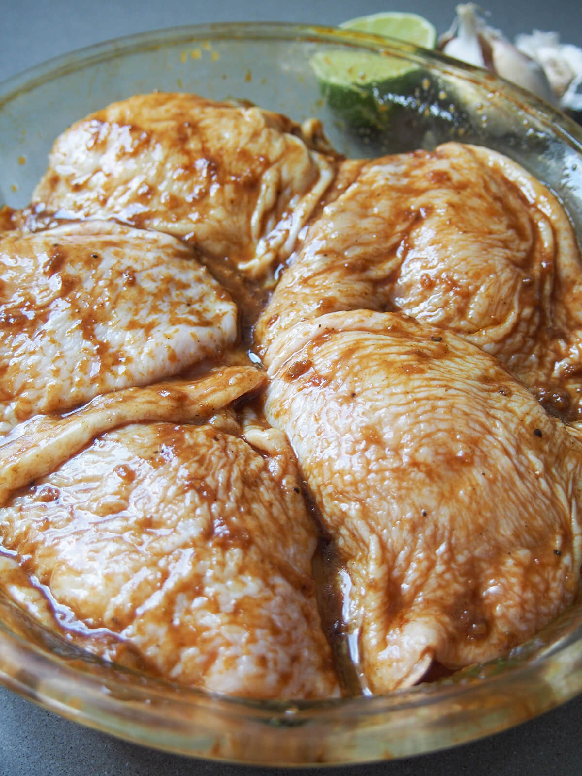 marinating pollo a la brasa, Peruvian roast chicken pieces of chicken in marinade