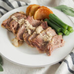 Milk-braised pork (maiale al latte) on plate with veg to side