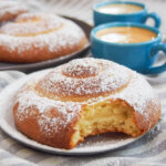 Pan de Mallorca (Puerto Rican sweet rolls) with one bitten into in front