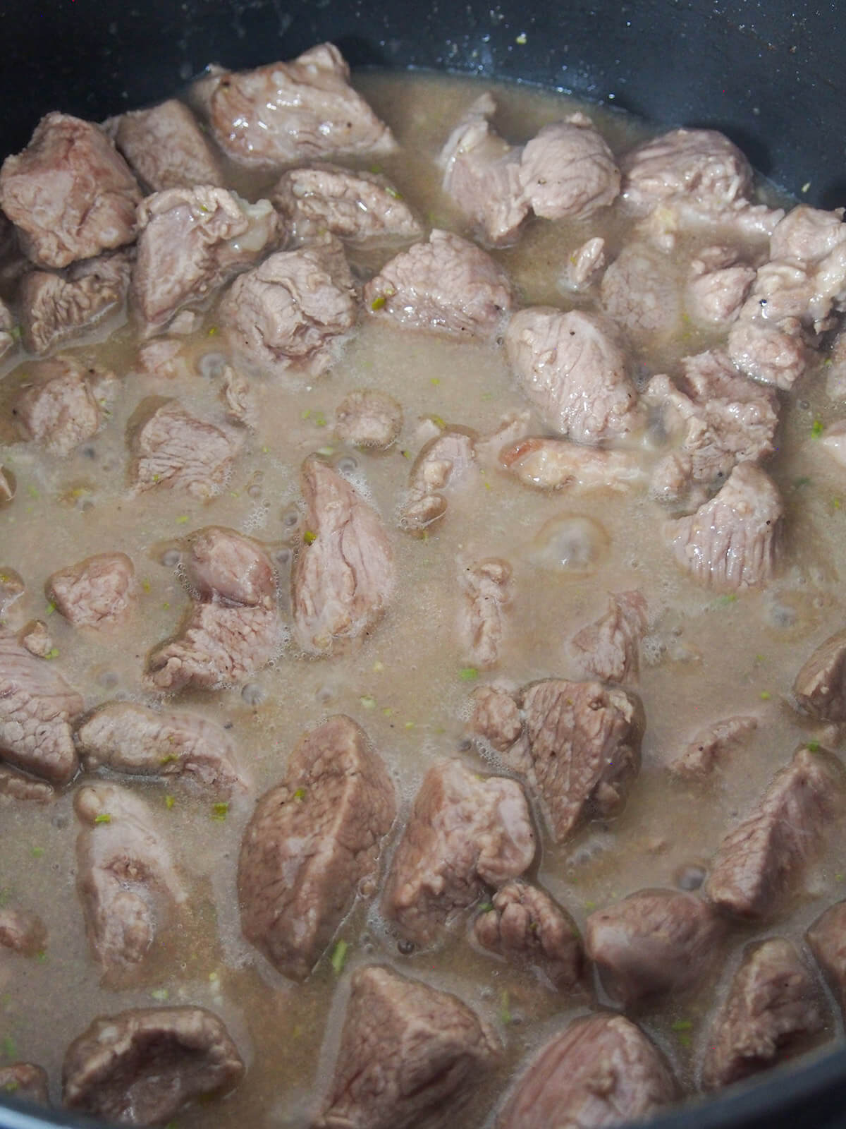 simmering Roman lamb stew in pot simmering lamb stew in pot