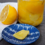 preserved lemons with jar behind and piece on plate