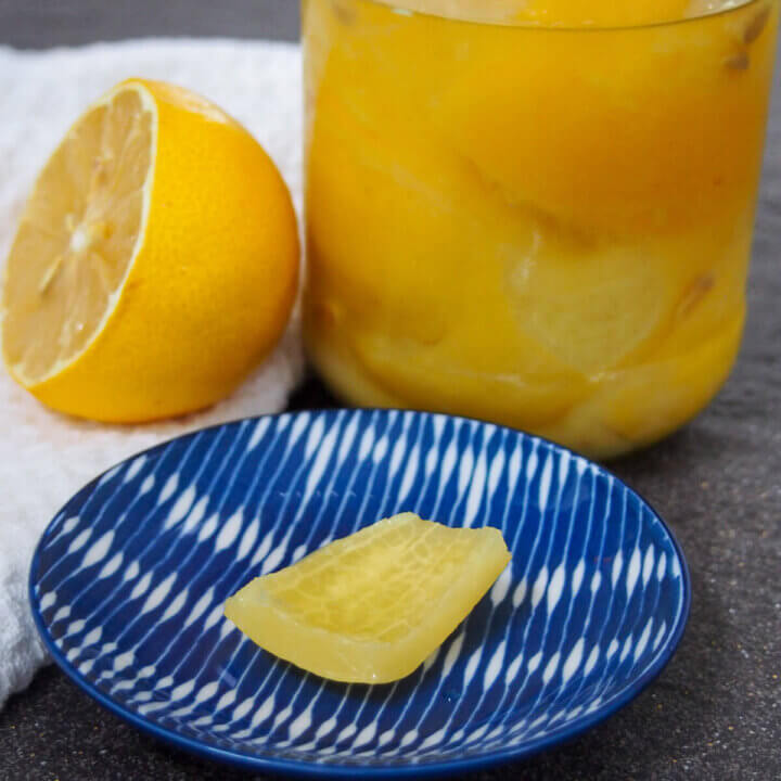 preserved lemons with jar behind and piece on plate
