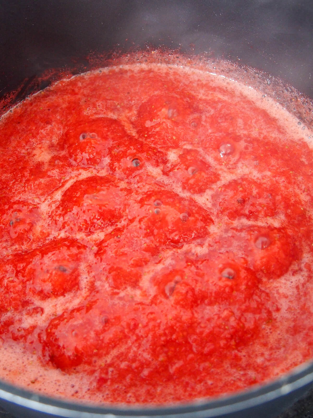 simmering sweetened strawberries to reduce mixture