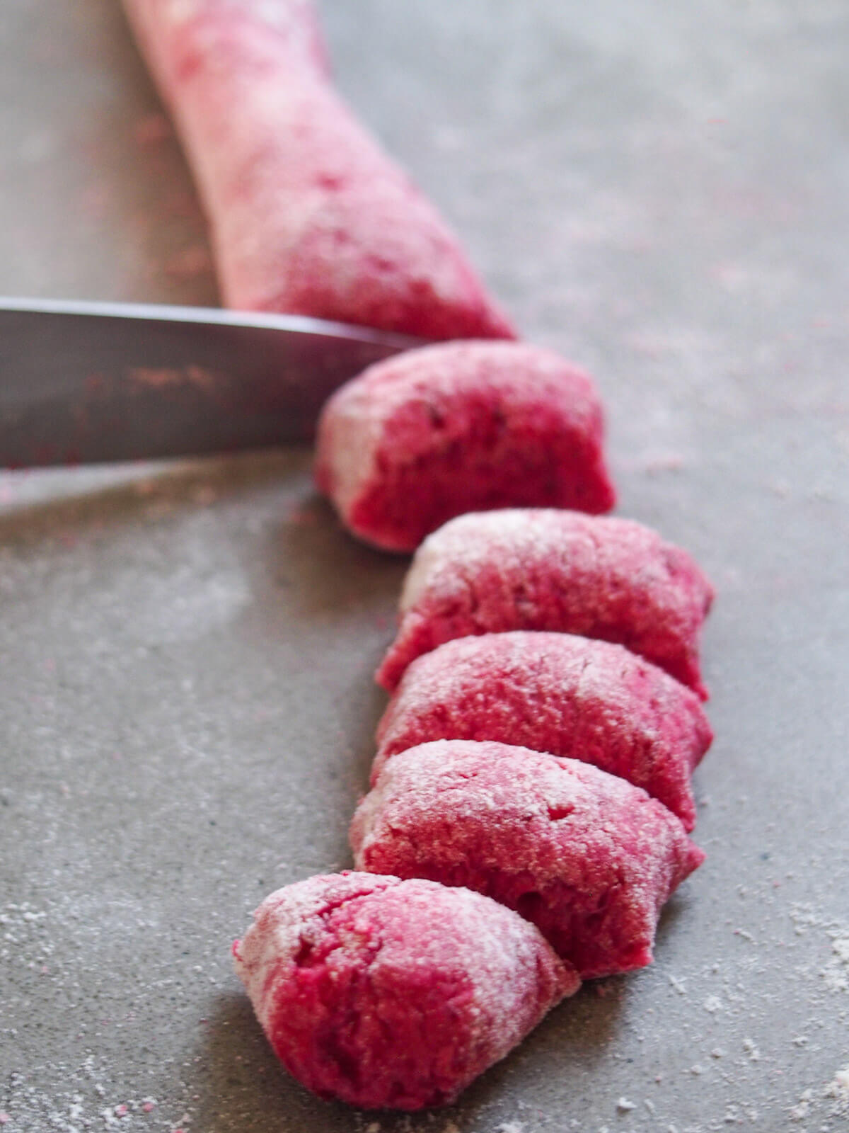 slicing roll of gnocchi mixture