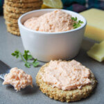 smoked salmon pate in dish, on oatcake and knife in front