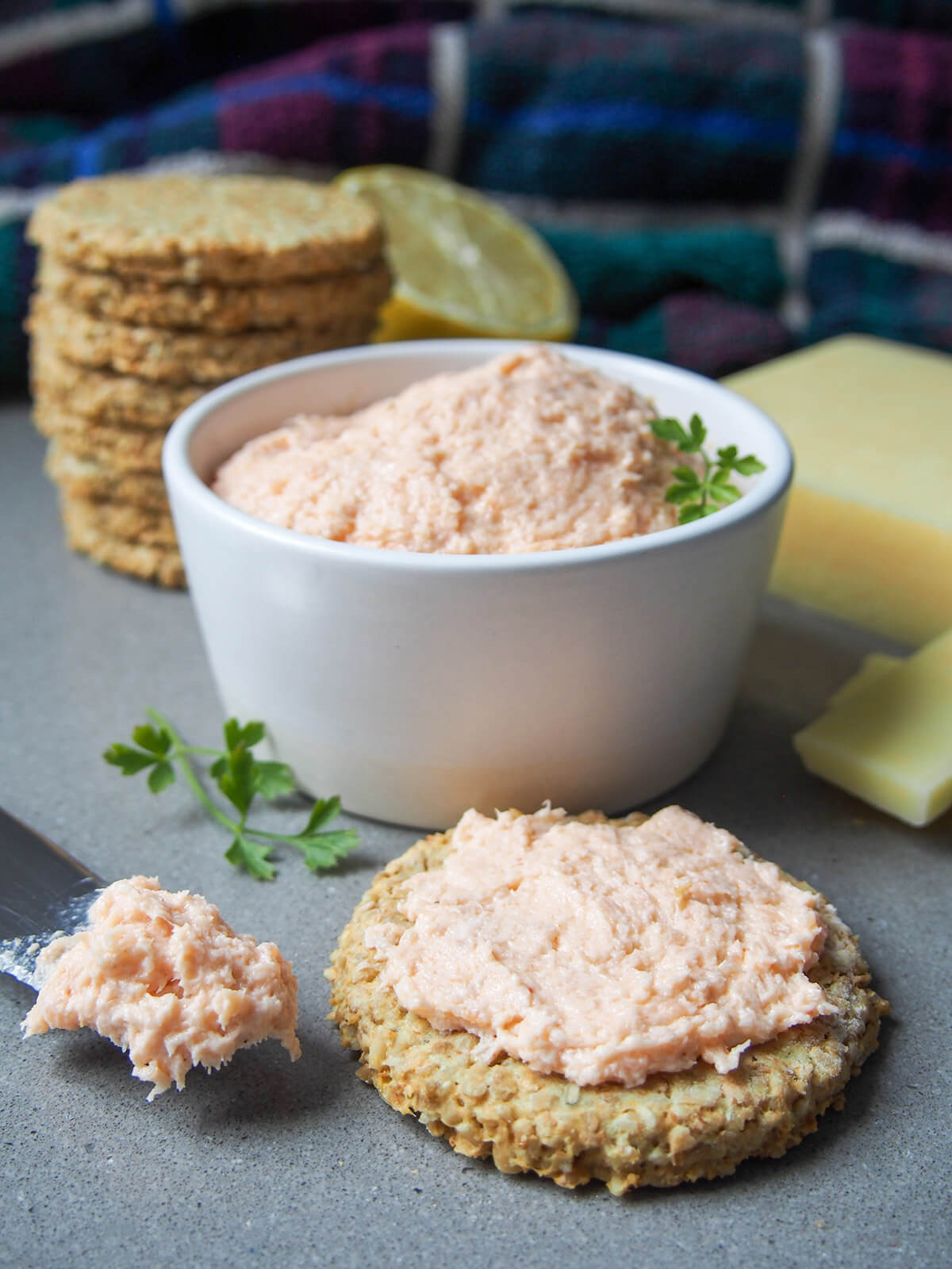 dish of smoked salmon pate with stack of oatcakes behind and oatcake with pate on in front