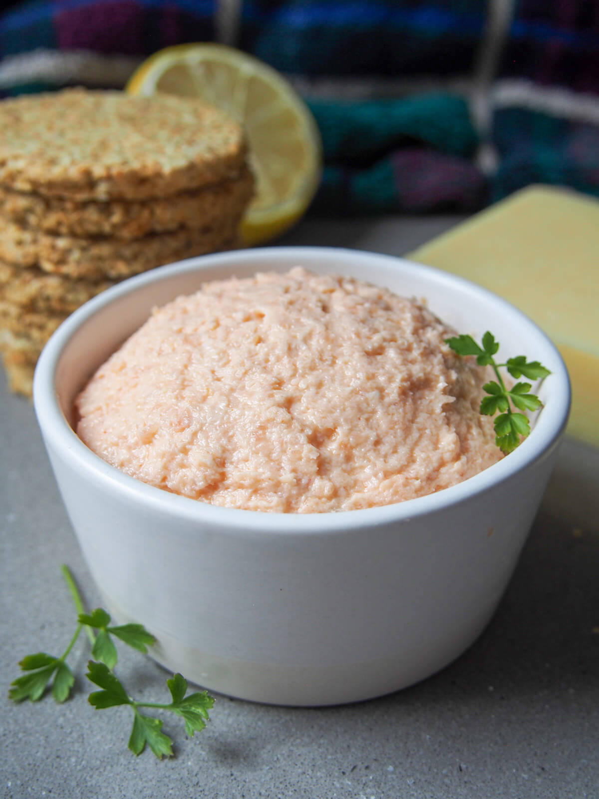 white dish full of smoked salmon pate with oatcakes behind