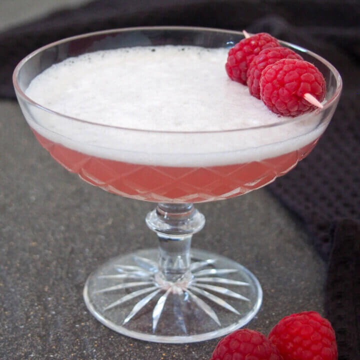 Clover club in Paris - a gin cocktail - topped with raspberries