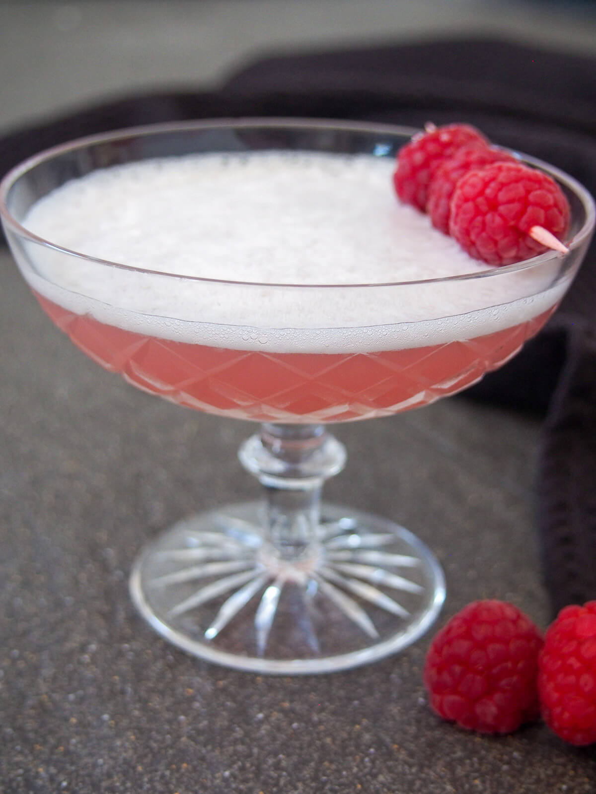 cocktail with raspberries to side