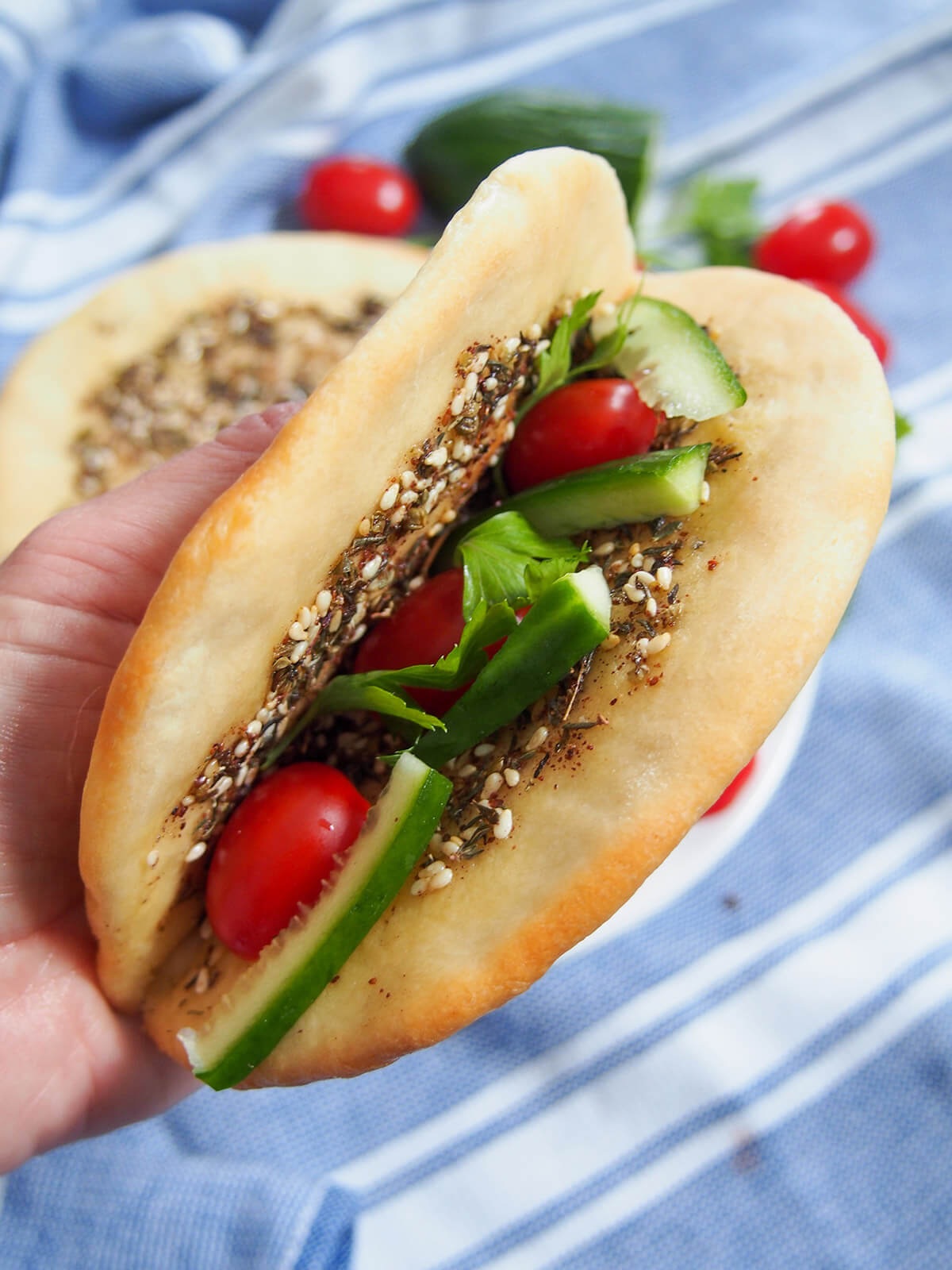 folded manoushe with tomato cucumber and parsley inside
