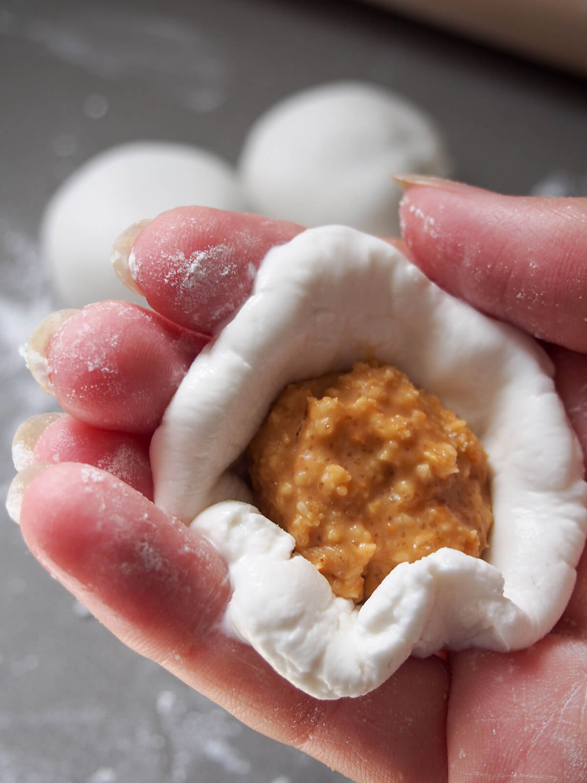 wrapping dough around peanut filling