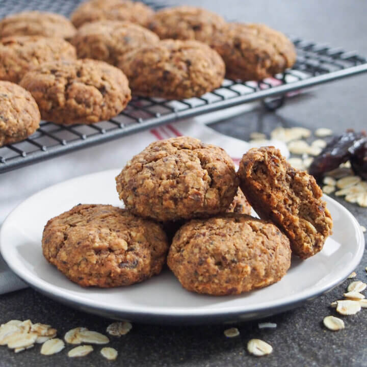 plate of oatmeal date cookies with one split open resting on side