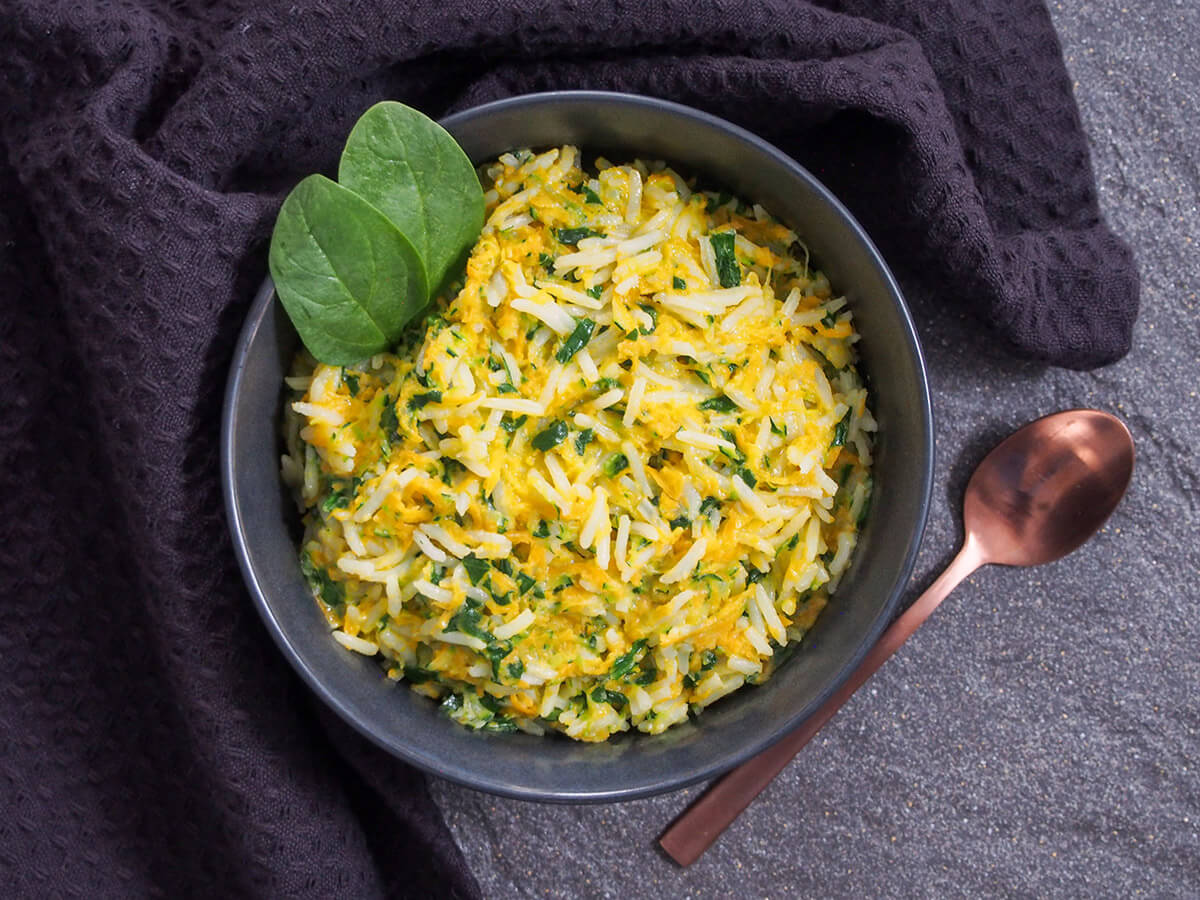 This rice with vegetables and coconut milk is extremely quick to make, using leftover rice, and makes a great side dish for a range of dishes. bowl of rice with vegetables and coconut milk with spoon to side of bowl