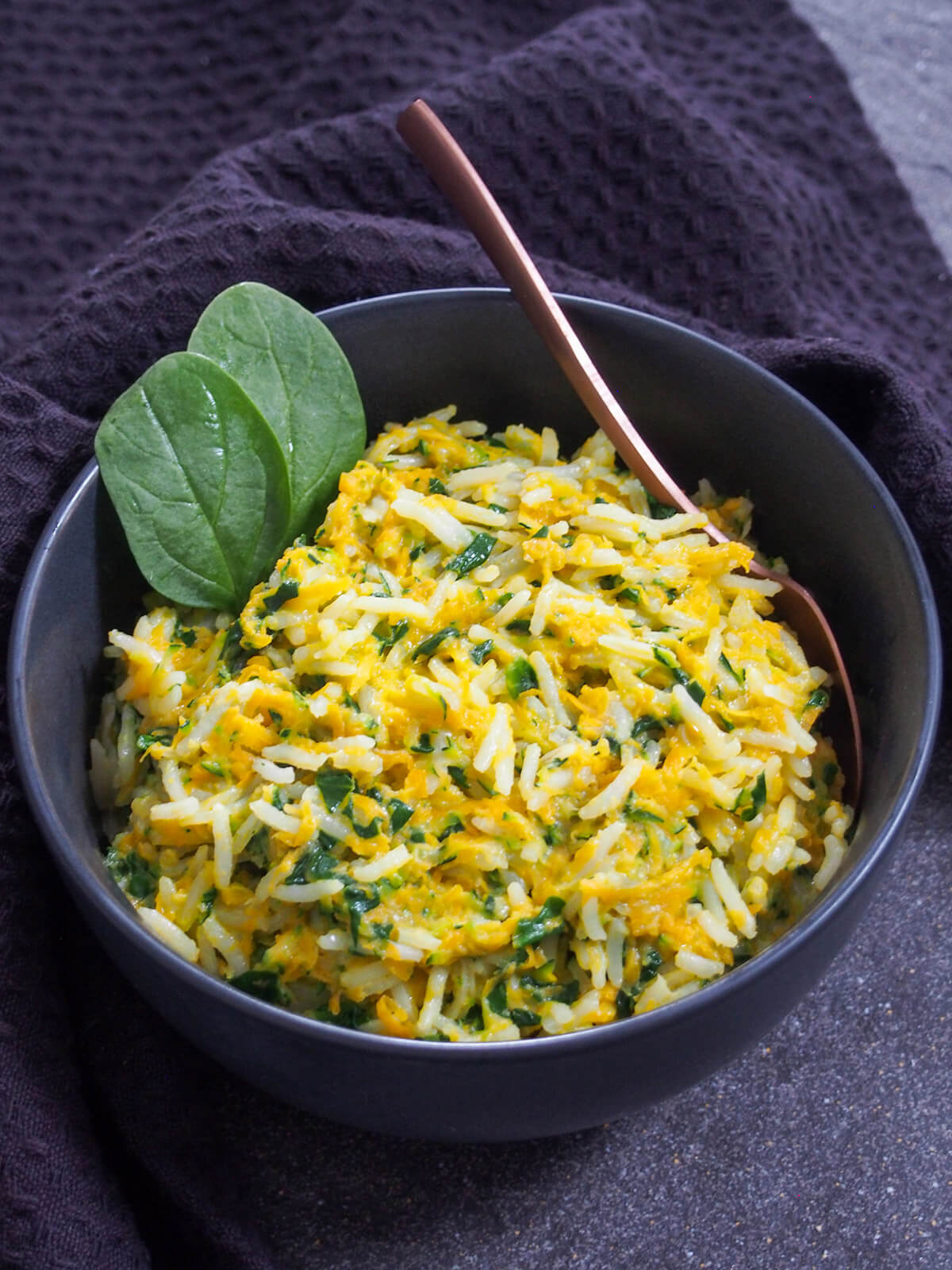 This rice with vegetables and coconut milk is extremely quick to make, using leftover rice, and makes a great side dish for a range of dishes. bowl of rice with vegetables and coconut milk with spoon in bowl
