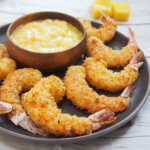 Baked coconut shrimp with mango dipping sauce behind