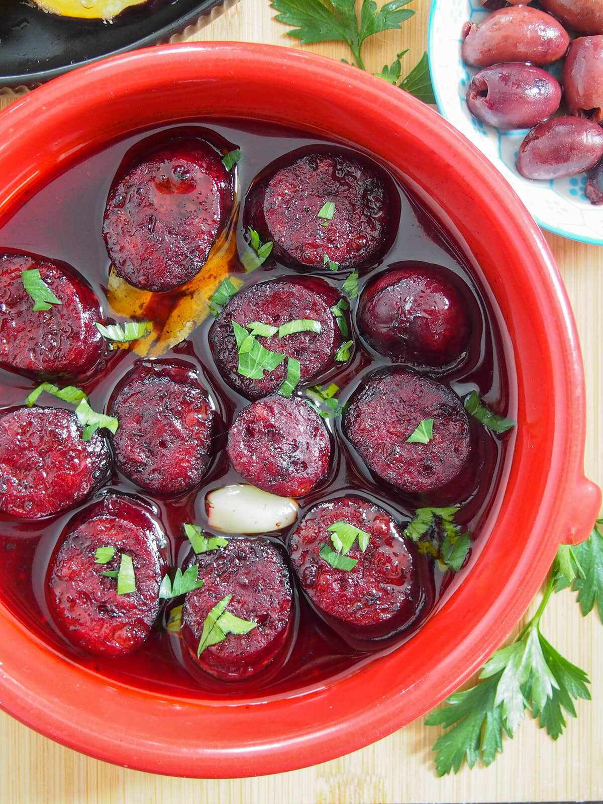 terracotta dish with Chorizo al vino tinto (chorizo in red wine)