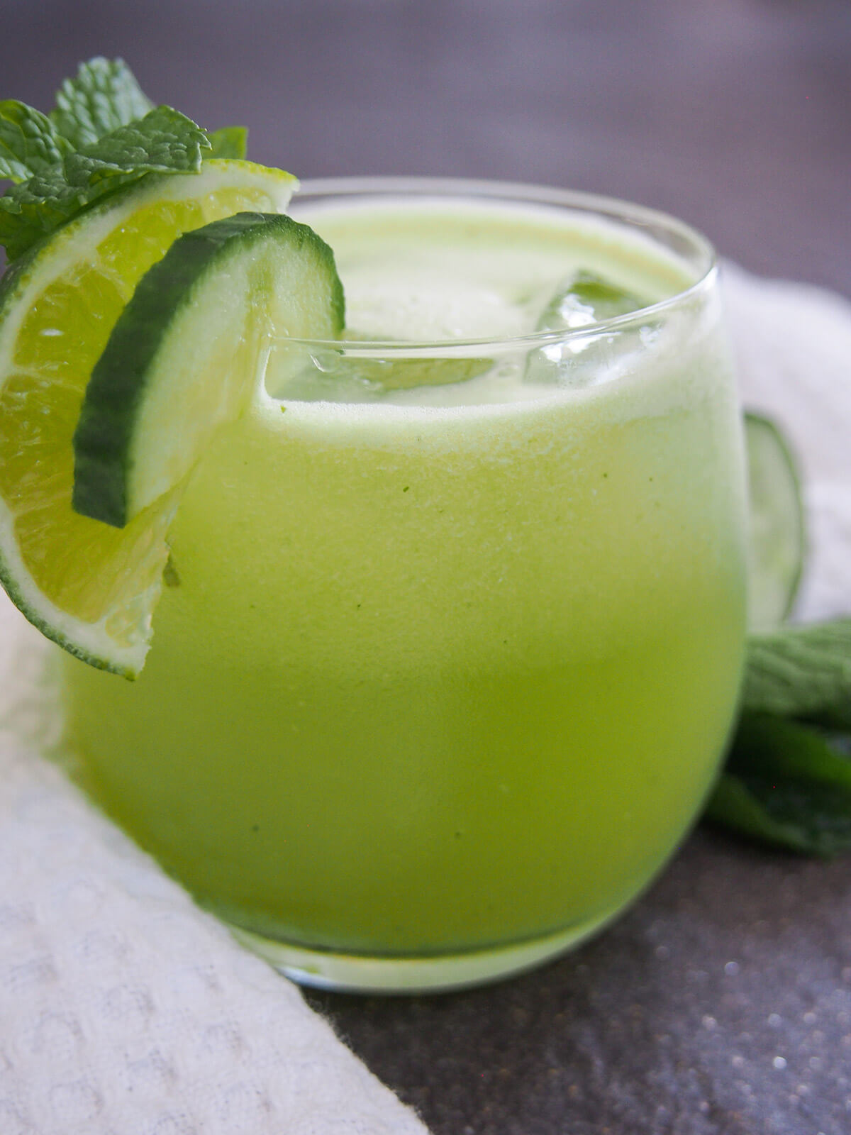 close up side view of glass of cucumber agua fresca