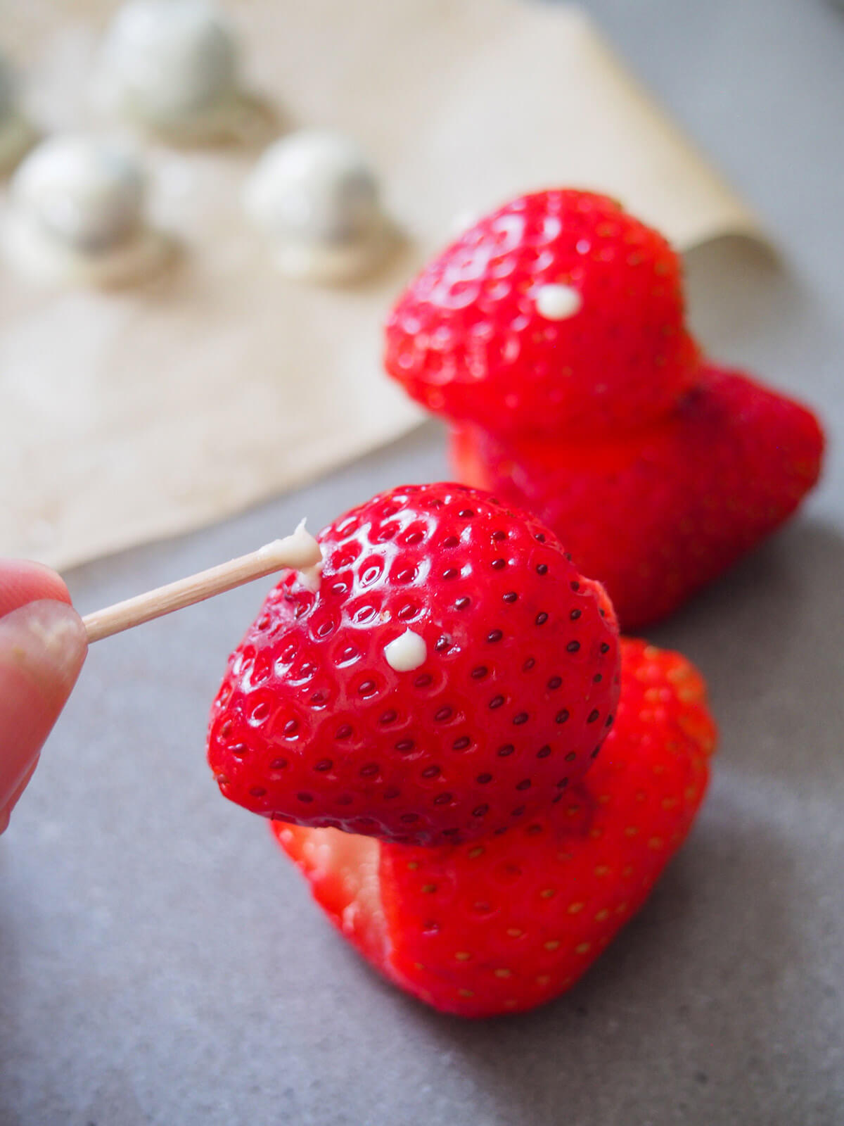 dotting white chocolate for eye on strawberry chick
