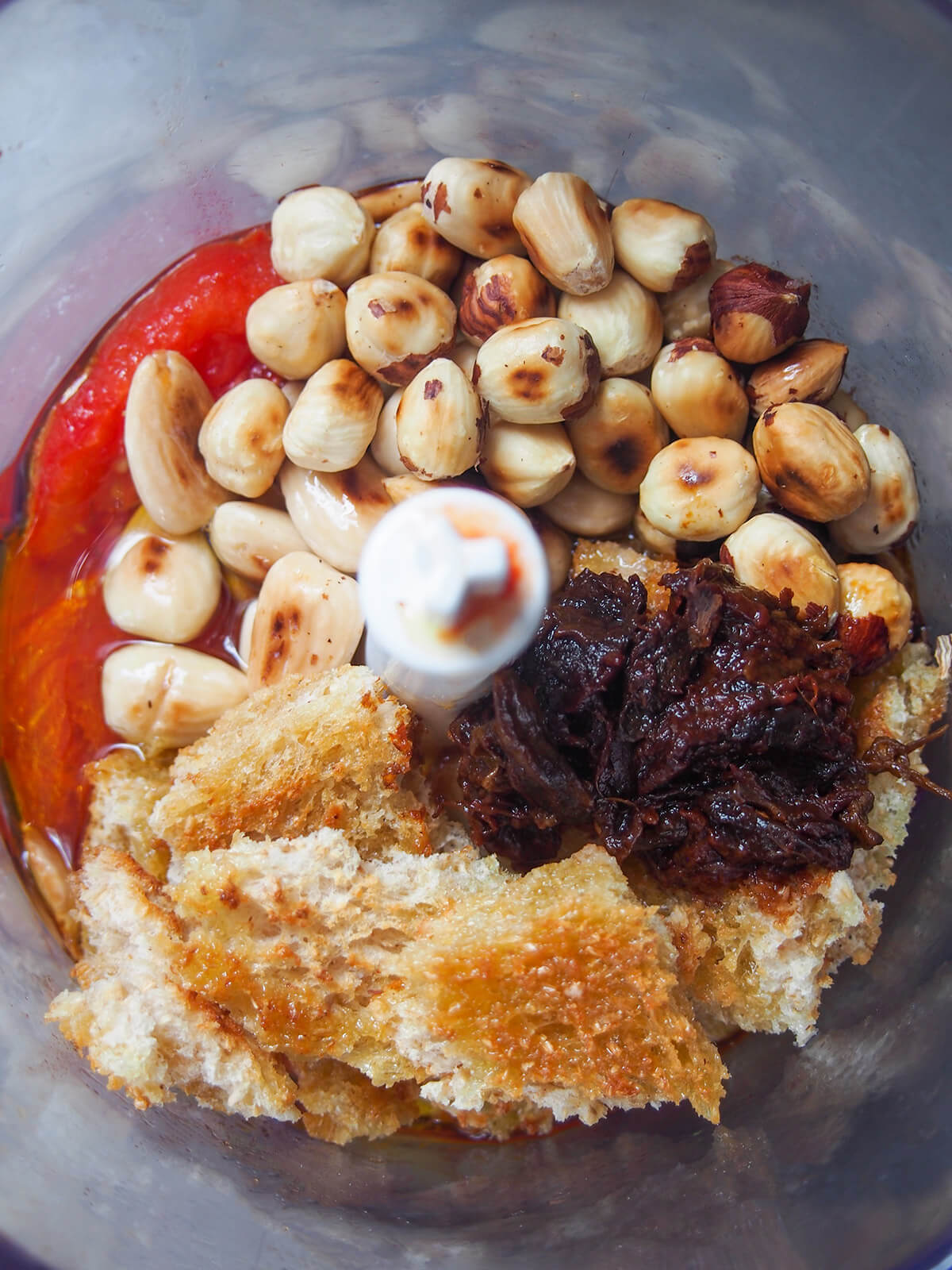 sauce ingredients (toasted nuts and bread on top) in blender