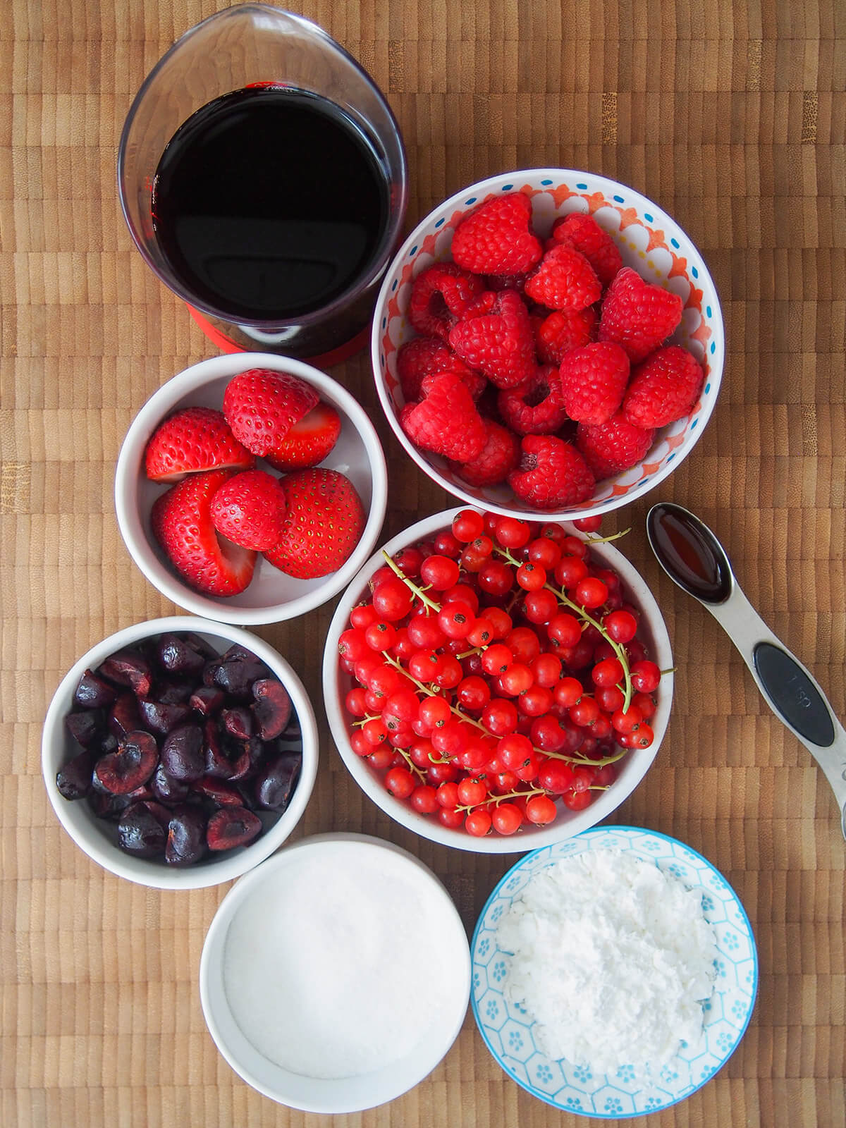 bowls of currants, raspberries, strawberries, cherries, sugar, corn starch and measure with cherry juice