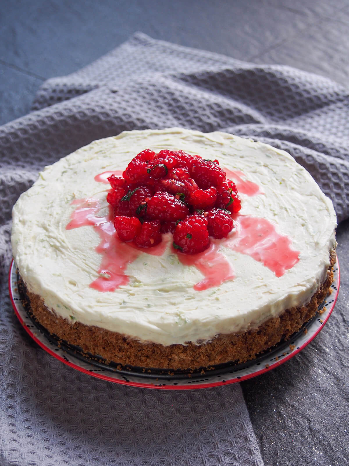 whole lime mascarpone cheesecake with raspberry topping