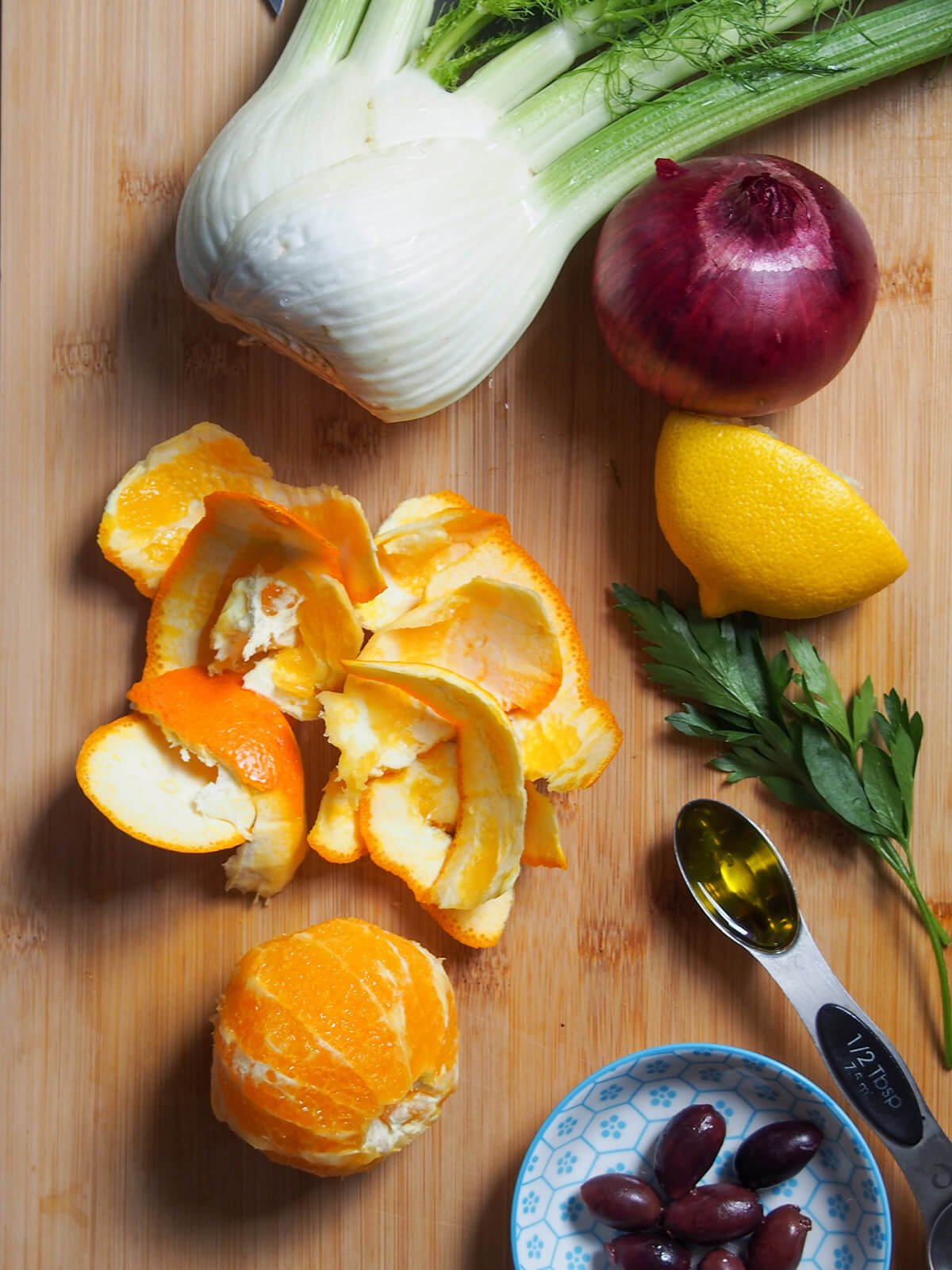 orange with skin removed to side and with fennel, red onion, olives around