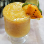 frozen pineapple daiquiri with pineapple and lime garnish