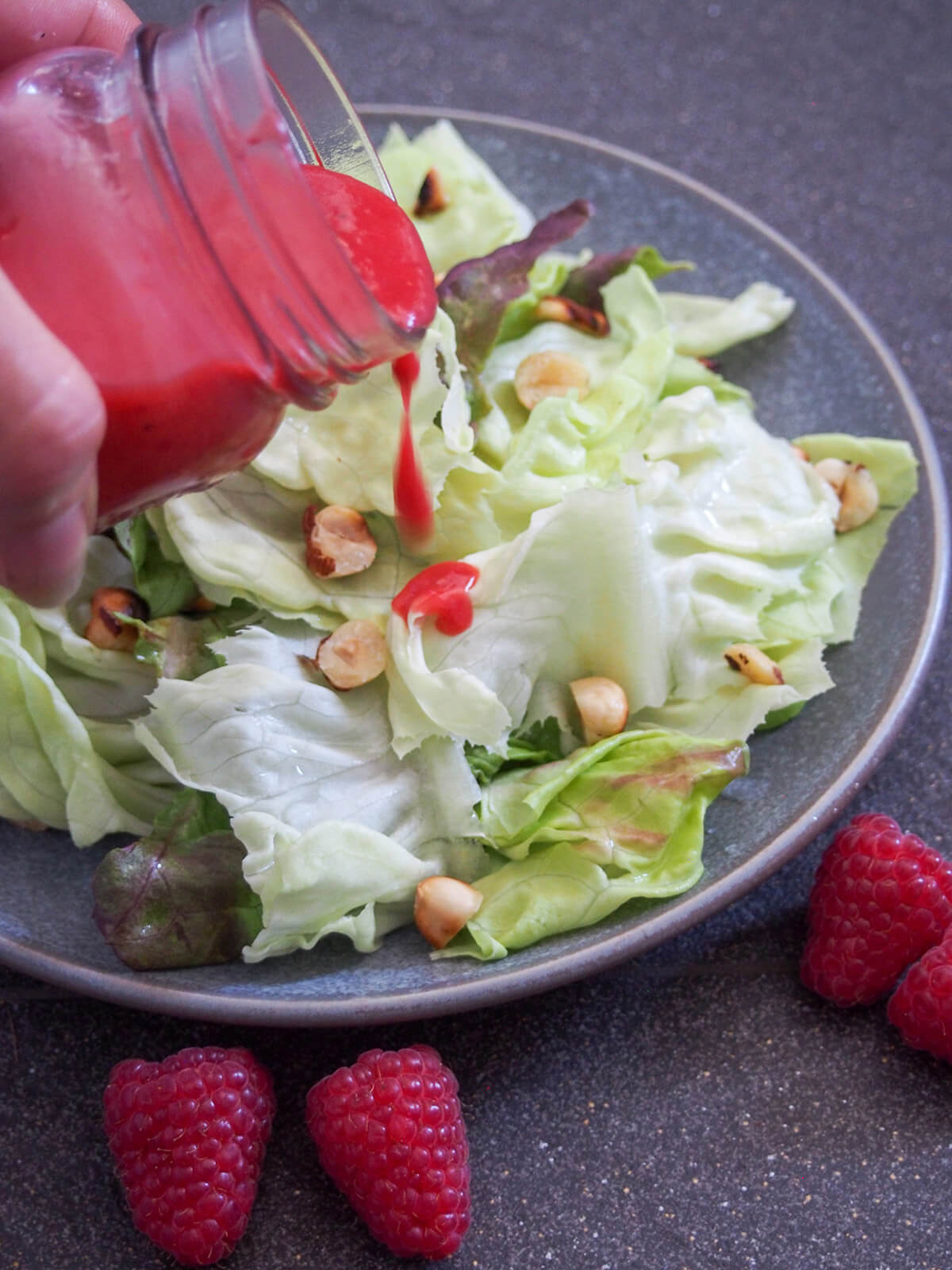pouring dressing over salad