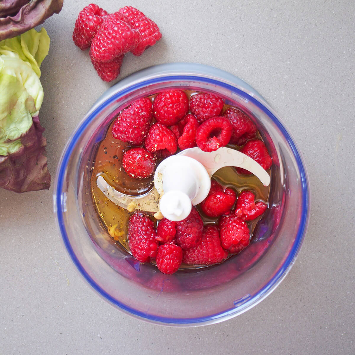 raspberries, oil and other ingredients in blender