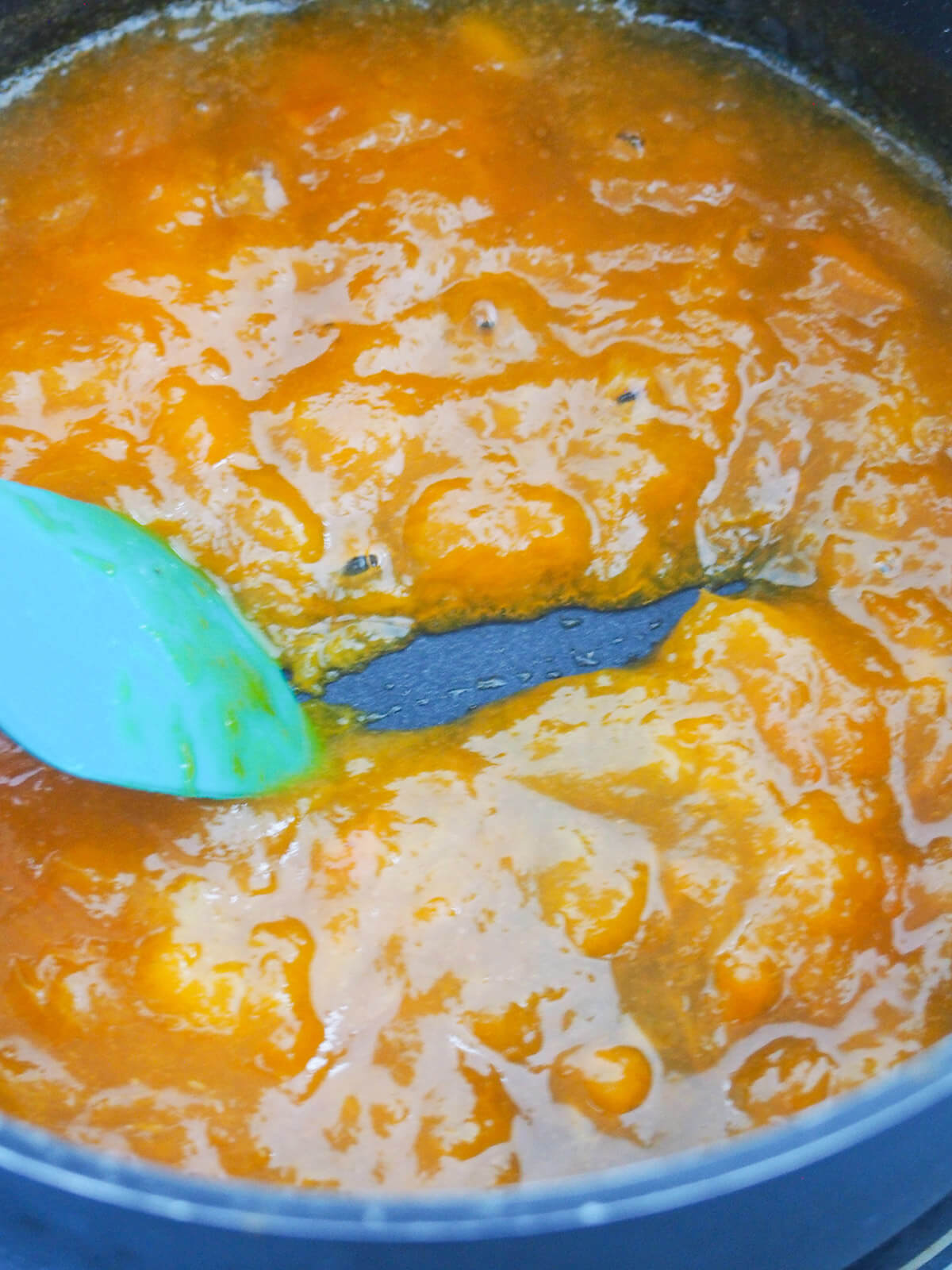 drawing spatula through reduced jam in pan