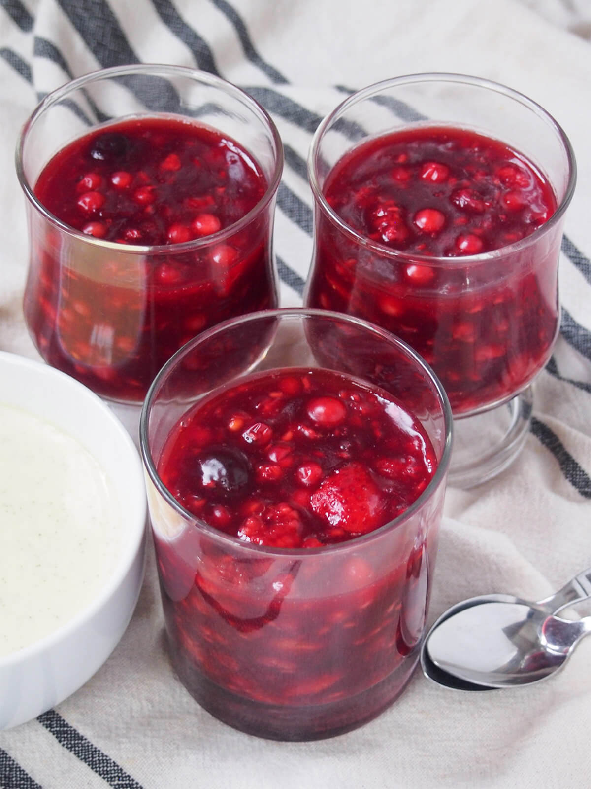 Three glasses of Rote Grütze (Rote Gruetze) showing berries in sauce