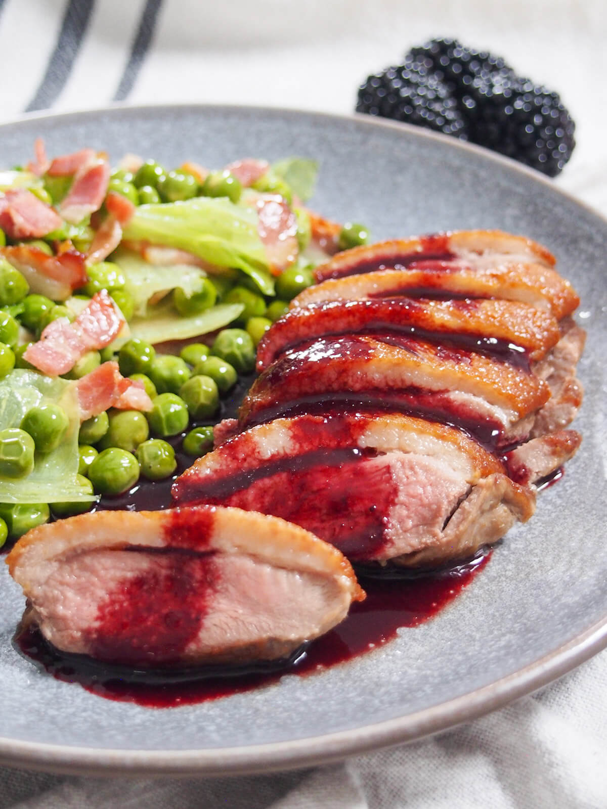 sliced pan seared duck breast with blackberry sauce