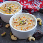 bowl of sheer khurma with nuts around bowl and decorating top
