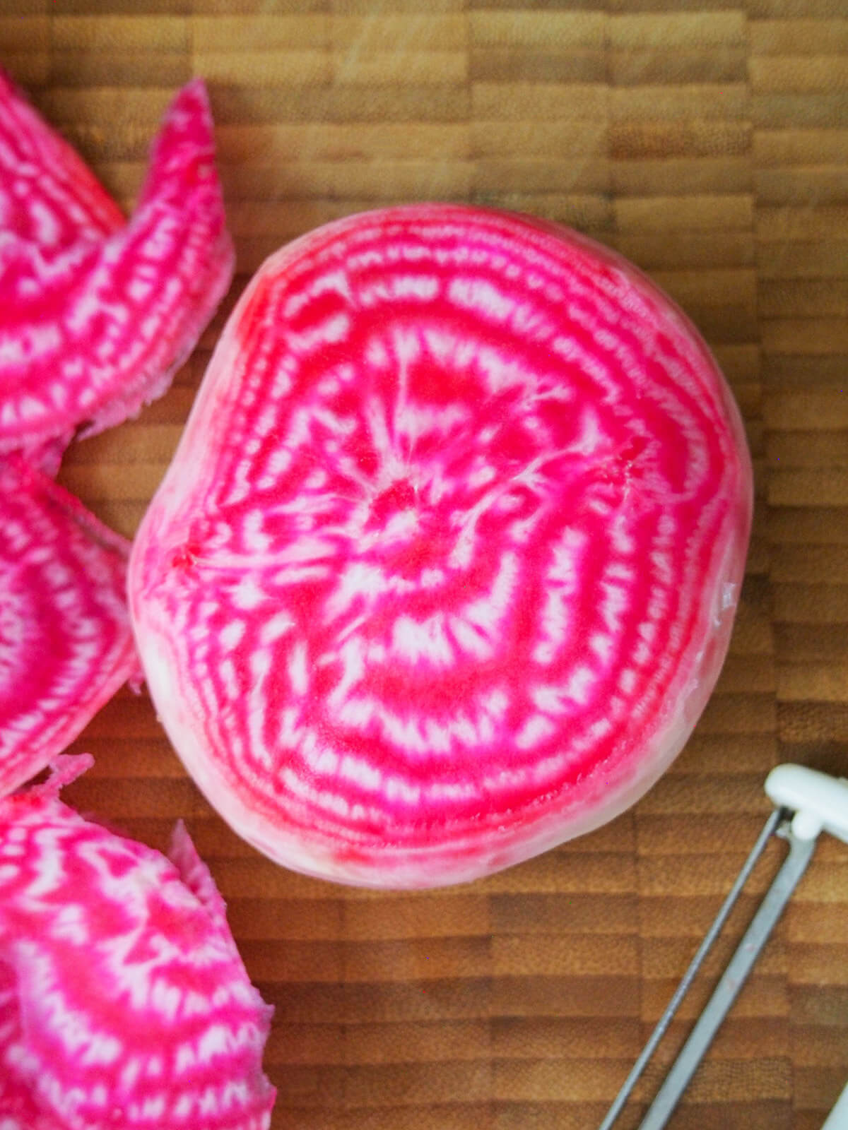 chioggia beet showing striped inside with peeler below beet