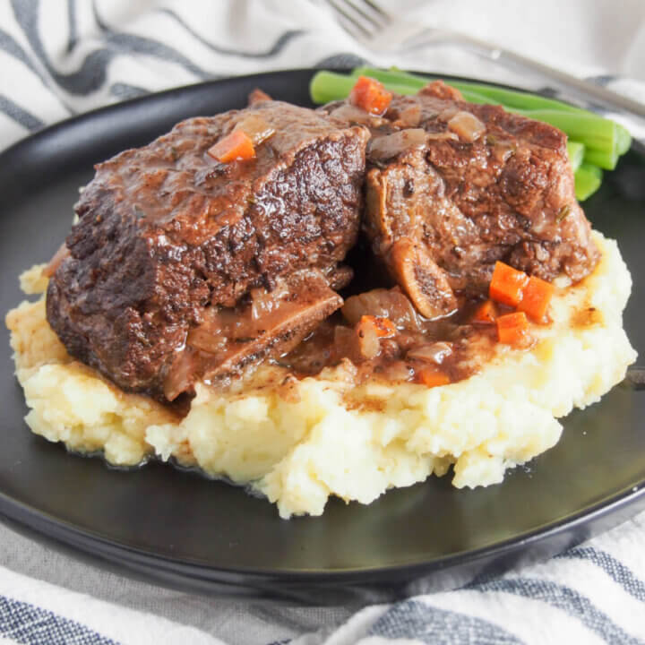 slow cooker short ribs served over mashed potato on plate