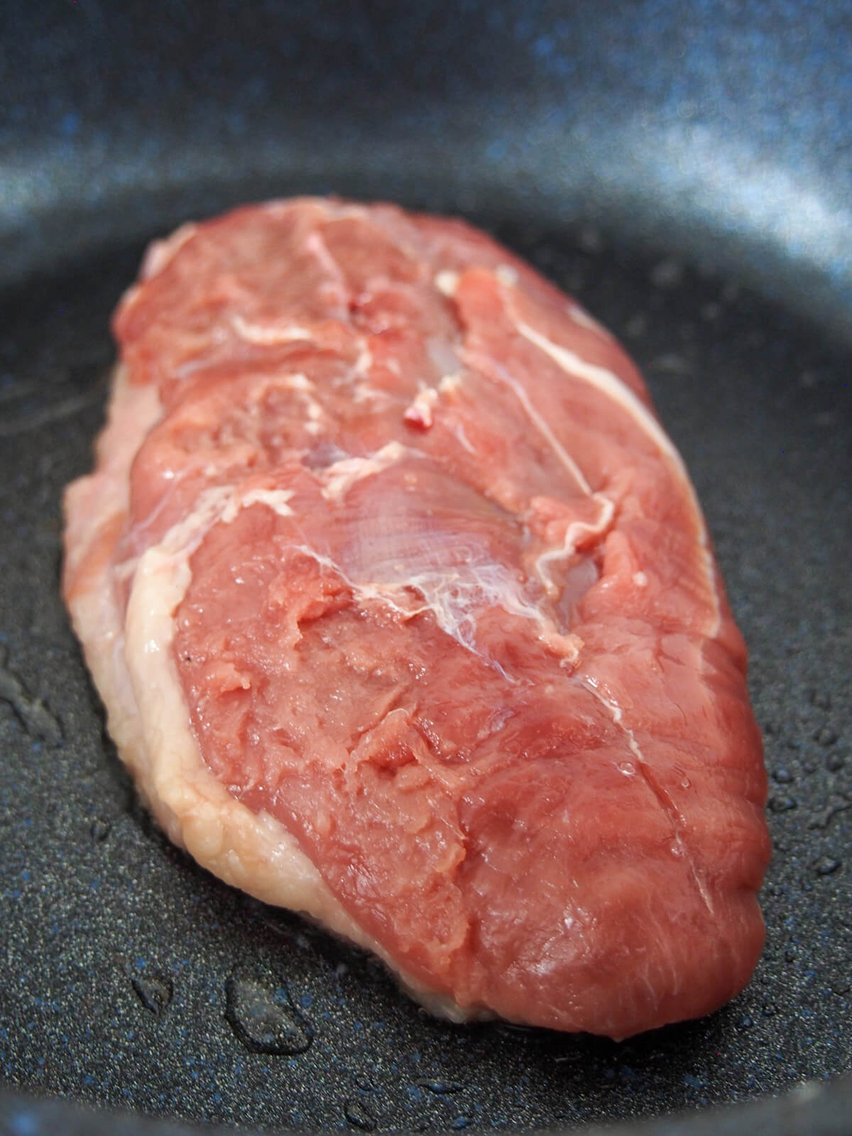 starting to cook duck breast in pan searing skin side down