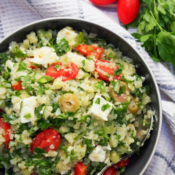 part view of bowl of Greek style cauliflower rice salad from overhead