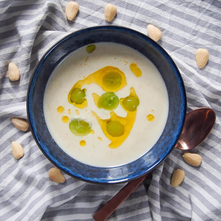 bowl of ajo blanco with spoon below bowl