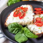 slices of basil ricotta toast with sprig of basil in front