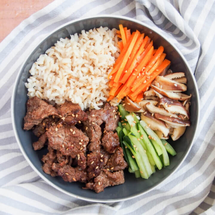 Bowl with beef bulgogi, rice and vegetable sides from above