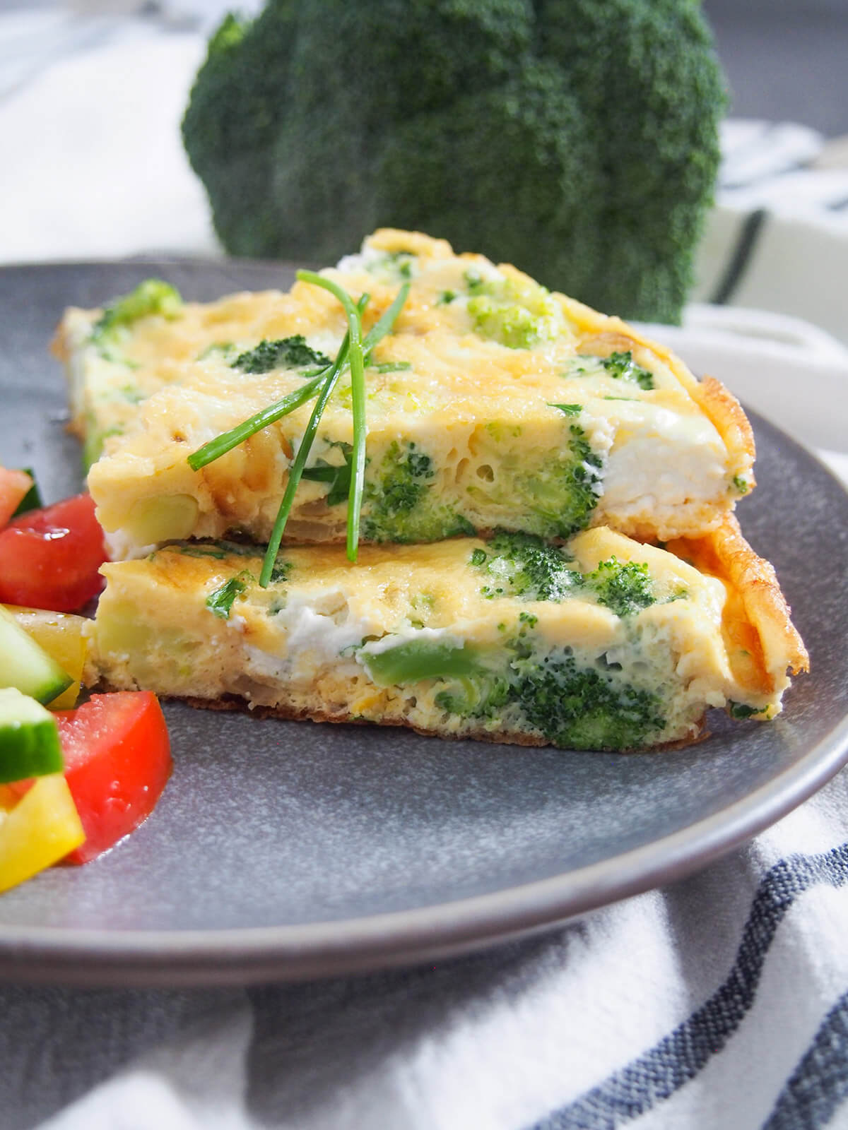 two pieces of broccoli goat cheese frittata stacked on top of each other